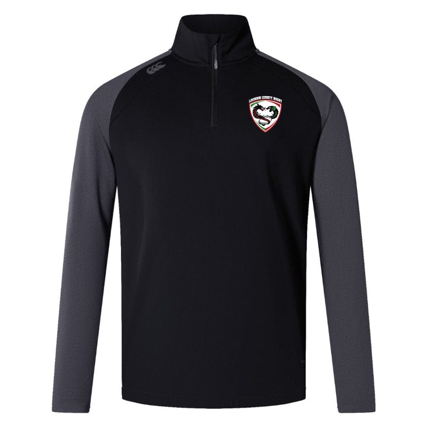 Introducing the Loudoun Elite First Layer by EMB Canterbury, a black and gray long-sleeve sports jacket with a quarter zip and team logo on the chest, perfect for rugby training. This attire features VapoDri technology to wick moisture away, ensuring comfort during intense workouts.