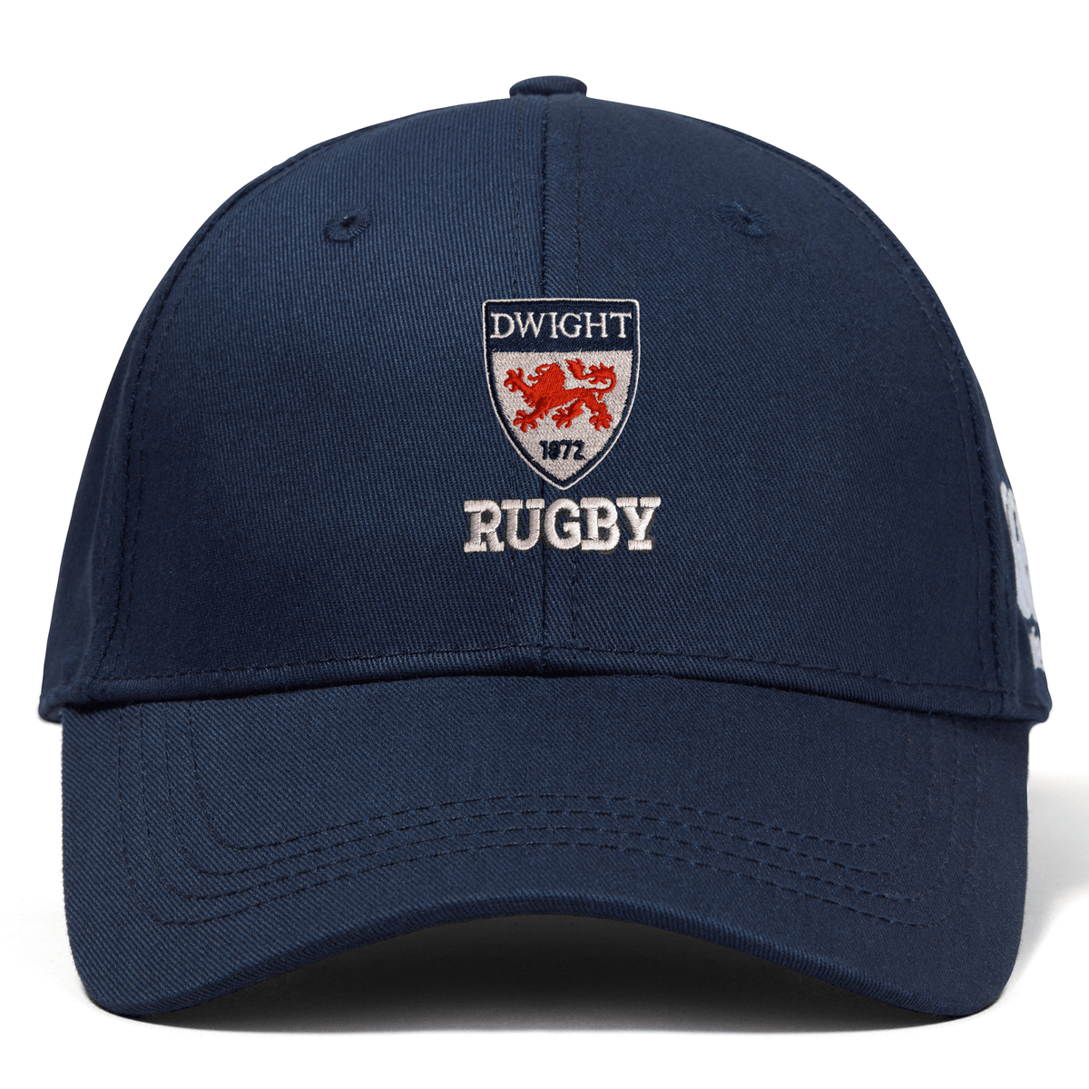 A navy blue EMB Canterbury Dwight Rugby Flexfit Drill Cap with a curved brim, embroidered logo "dwight rugby," and a red crest featuring a lion, dated 1972.