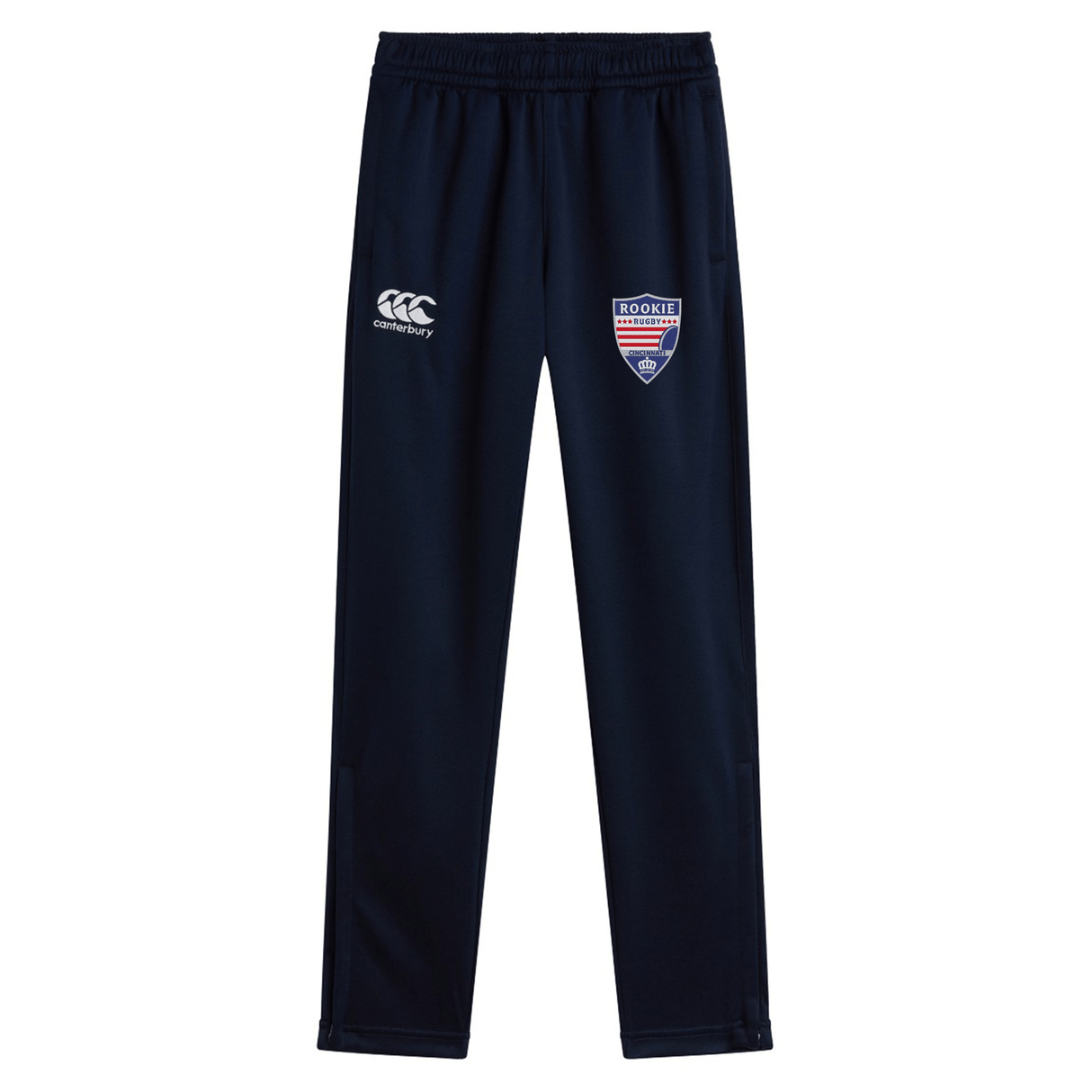 Navy blue workout pants with embroidered logos, featuring a white "EMB Canterbury" logo on the right leg and a shield emblem with "Rookie Rugby" text on the left leg. Crafted from quick-dry fabric, these Cincinnati Rookie Rugby Stretch Tapered Pant by Canterbury offer both style and performance.