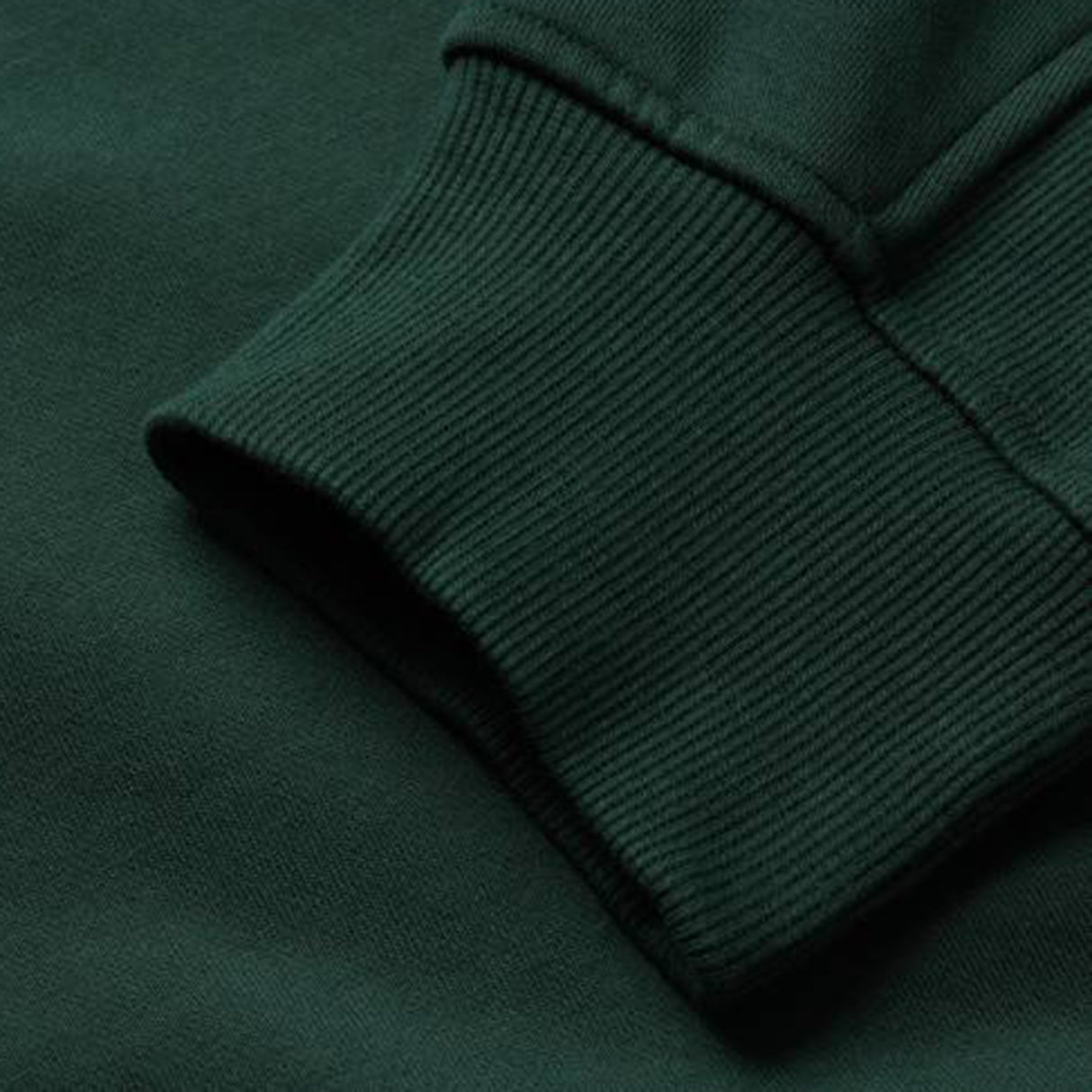 Close-up of a dark green sweatshirt sleeve and cuff featuring ribbed knit texture and stitching details, highlighting the craftsmanship of the Canterbury Ireland 26 Leisure Hoodie.