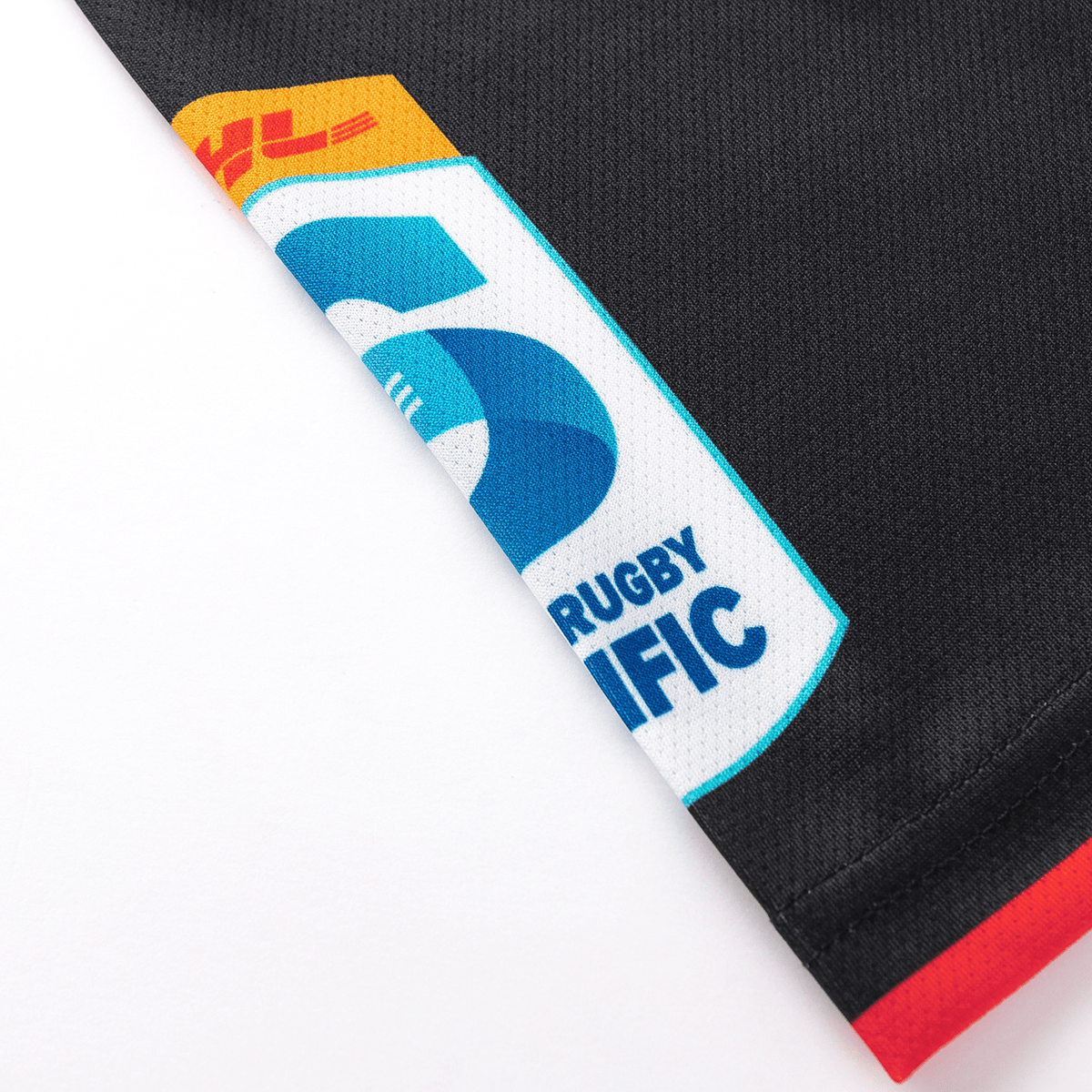 Close-up of a black moisture-wicking fabric with an embroidered "Rugby" and "Pacific" logo, part of the Crusaders Super Rugby Team Polo 25/26 by Classic Sportswear.