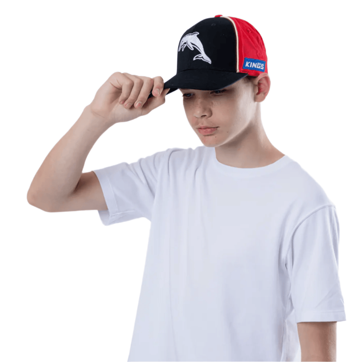 A person wearing a white t-shirt tilts a black and red Dolphins NRL 25/26 Media Cap by Classic Sportswear featuring a dolphin logo.