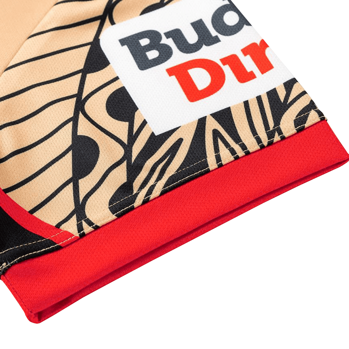 Close-up of the Dolphins Indigenous NRL 25/26 Replica Jersey by Classic Sportswear, featuring beige and black patterns, bold lines, red and black text on a white Classic Sportswear label, and a red hem.