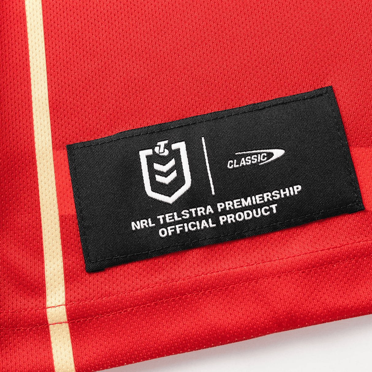 The Dolphins NRL 26/27 Replica Home Jersey by Classic Sportswear is a red jersey featuring an official NRL patch and Classic Sportswear logo—ideal for dedicated Dolphins fans seeking authentic home game style.