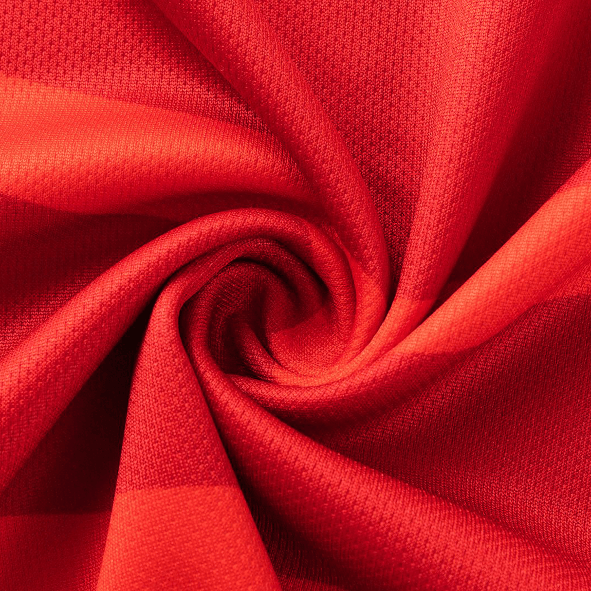Close-up of vibrant red fabric with a textured pattern, twisted into a spiral—evoking the dynamic material of the Dolphins NRL 26/27 Replica Home Jersey by Classic Sportswear.