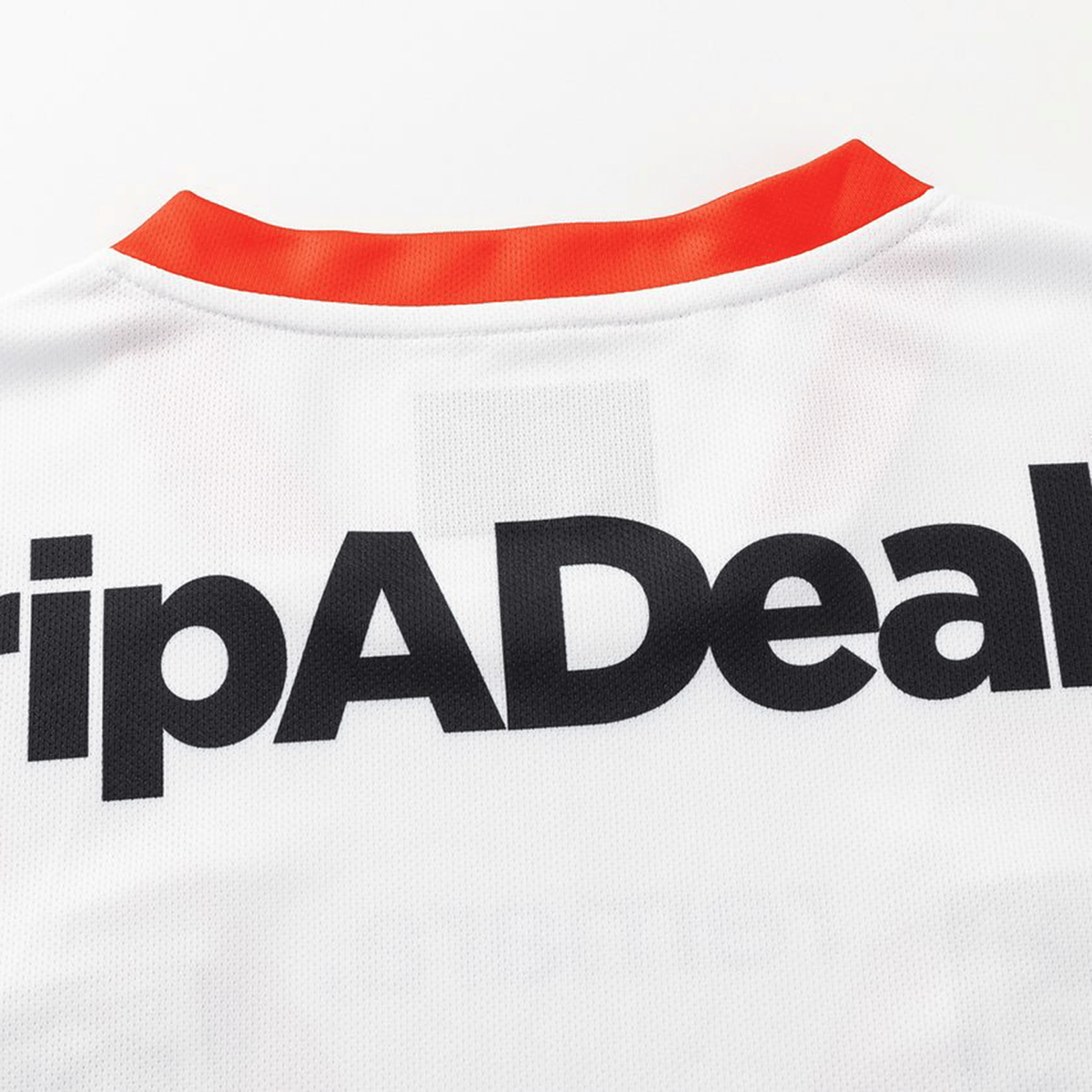 Close-up of the upper back of the Dragons NRL 26/27 Replica Home Jersey by Classic Sportswear, featuring black "tripADeal" text and a red collar—a classic rugby jersey.