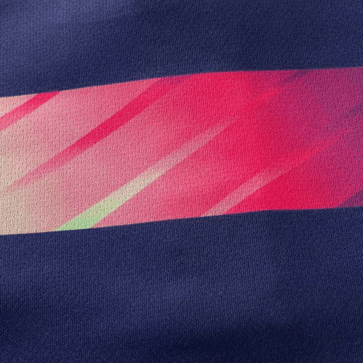 The Highlanders Super Rugby Team Polo 25/26 by Classic Sportswear features a close-up of moisture-wicking fabric in navy blue with diagonal pink stripes and subtle gradient effects, ideal for crafting a stylish rugby polo.