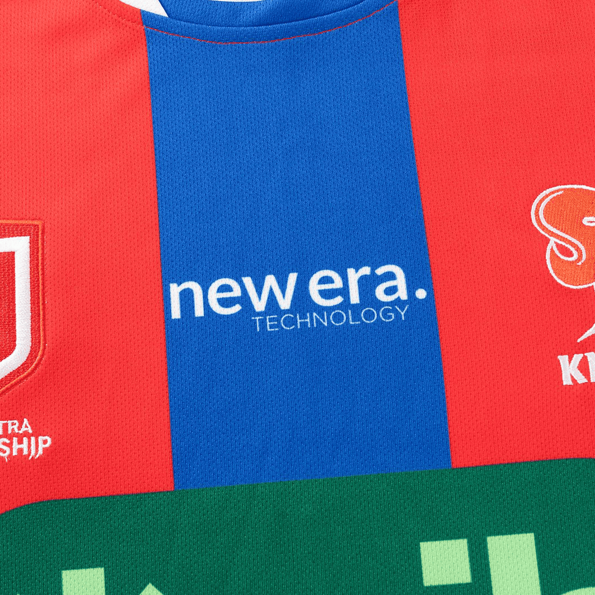 Close-up of the Knights NRL 26/27 Replica Home Jersey by Classic Sportswear, showcasing red and blue vertical stripes, moisture-wicking fabric, and "new era. TECHNOLOGY" printed in bold white text across the front.