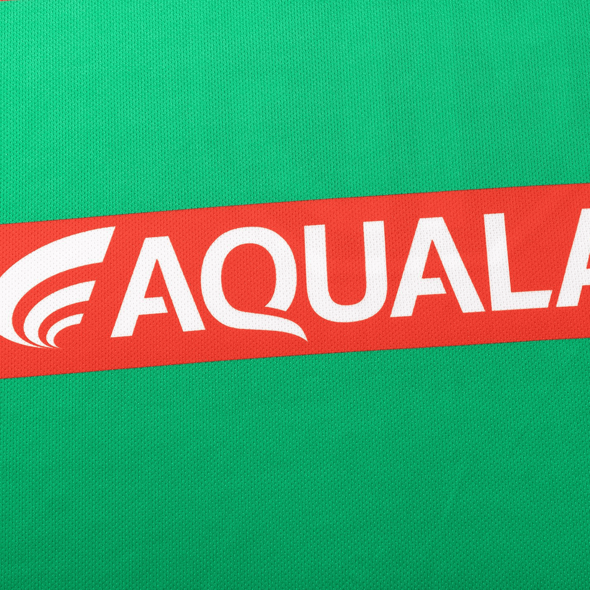 A green background with a red diagonal stripe showcases "AQUALAND" in bold white letters, echoing the style of the Rabbitohs NRL 25/26 Replica Home Jersey by Classic Sportswear.