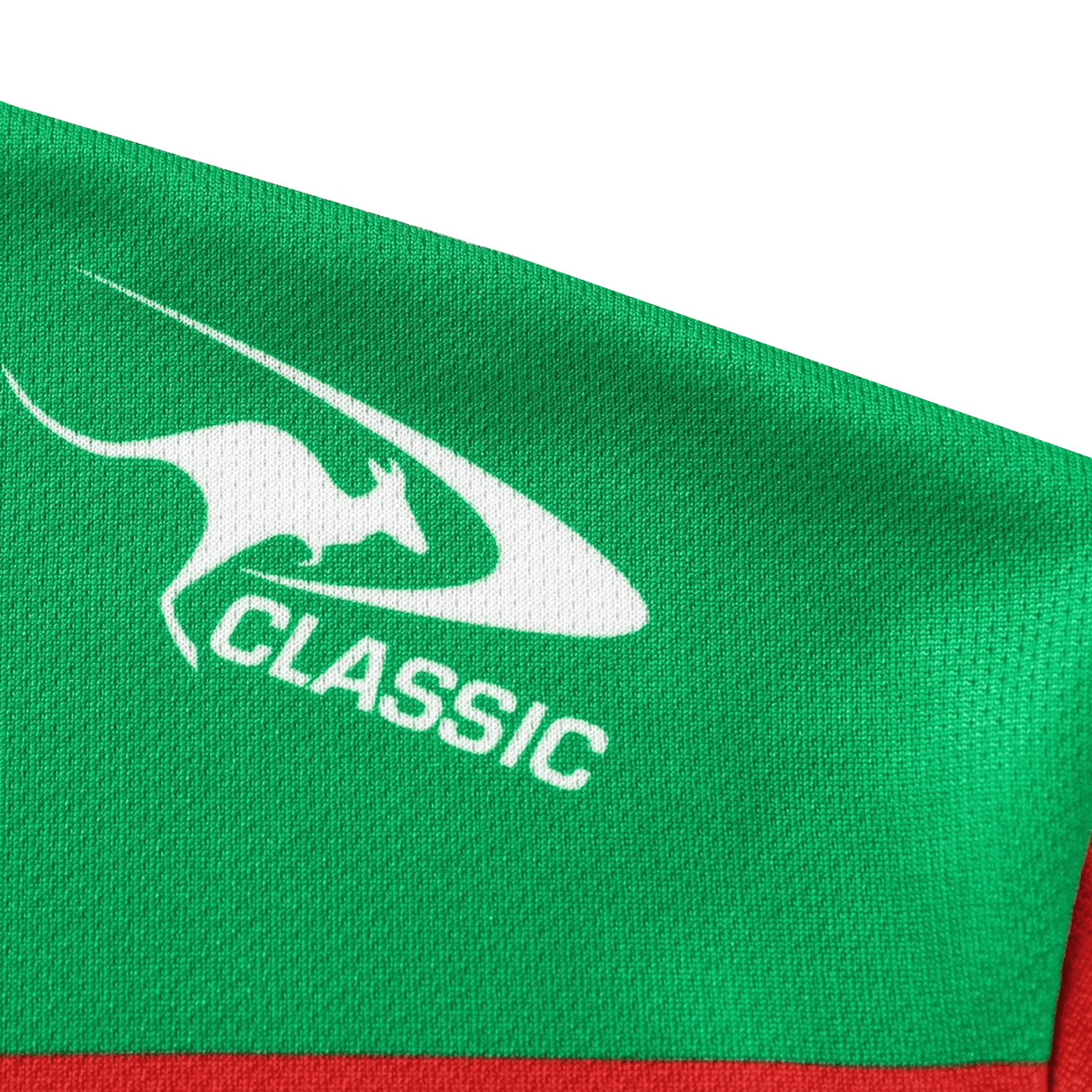 A close-up of green fabric with a white kangaroo logo and "CLASSIC" text, showing the detail of the Rabbitohs NRL 26/27 Replica Home Jersey by Classic Sportswear.