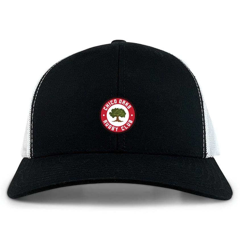 The Chico Oaks Retro Trucker Cap by EMB S&S Activewear features a black and white design, circular "Chico Oaks Rugby Club" embroidery with an oak tree on the front, and an adjustable snapback closure.