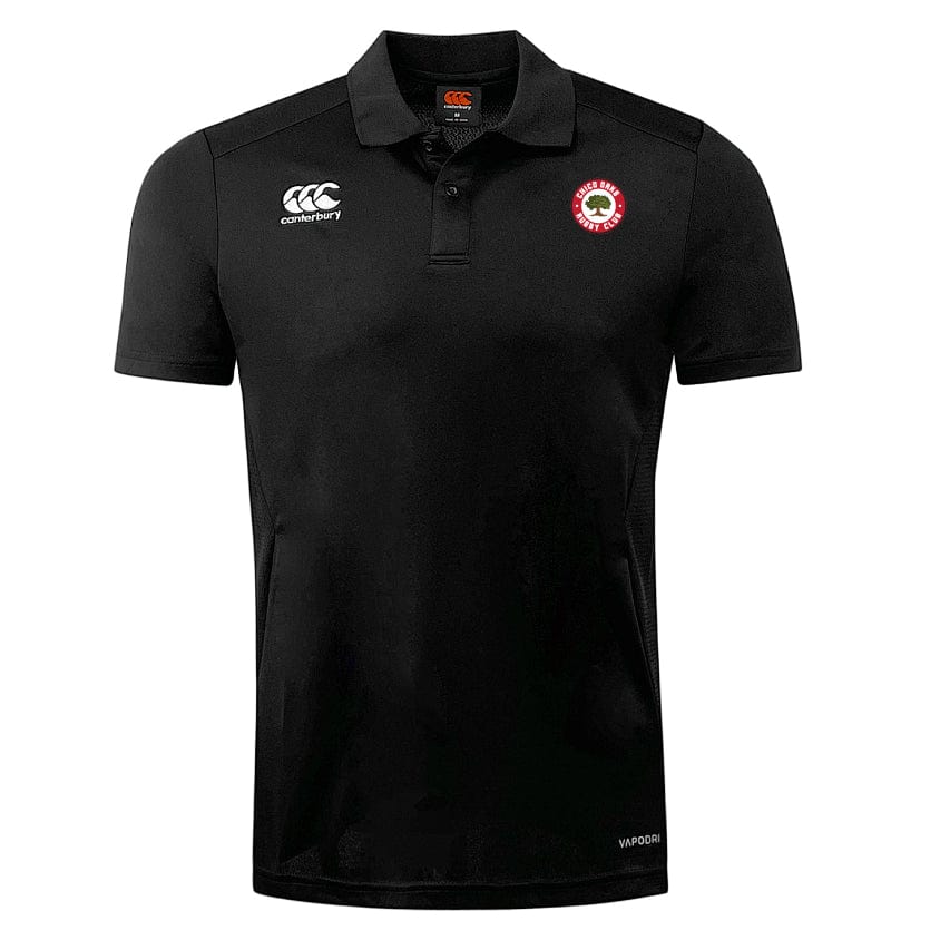 Explore the Chico Oaks Club Dry Polo by EMB Canterbury, a black polo with Vapodri Technology for optimal comfort. It features the Canterbury logo on the right chest and a round red emblem on the left, blending style and performance seamlessly.