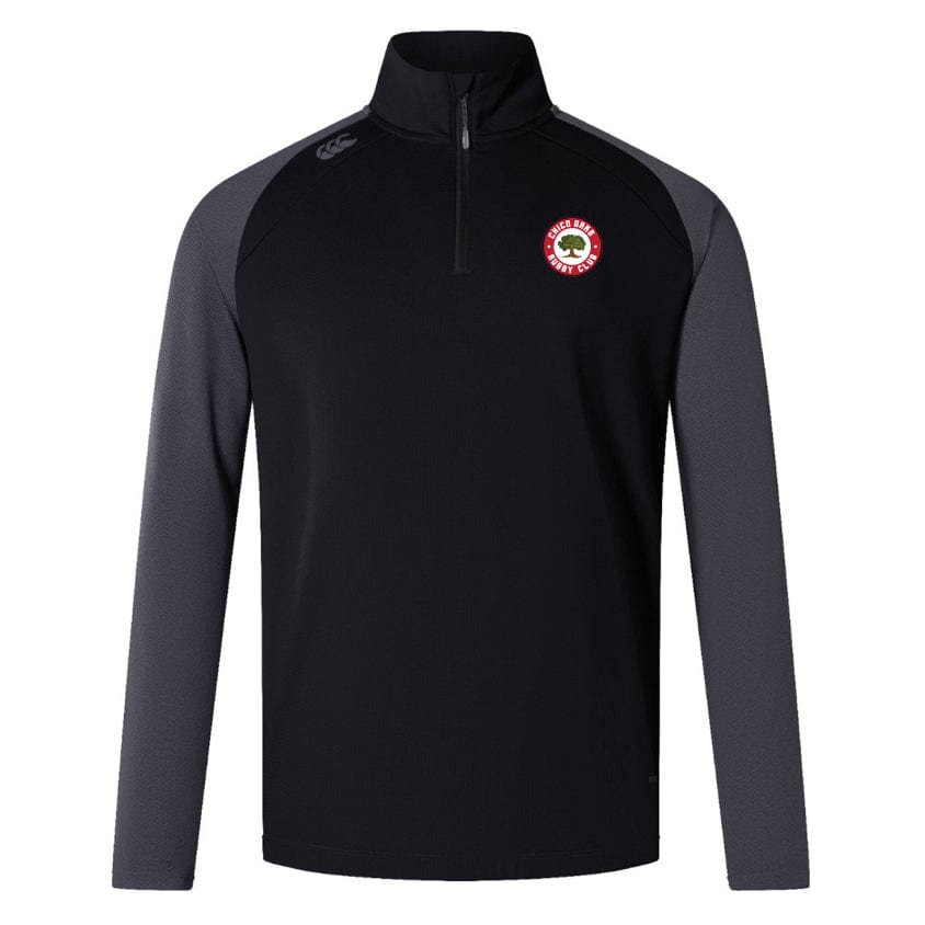 The black and gray long-sleeve quarter-zip pullover features a circular red and white chest logo. As the Chico Oaks Elite First Layer by EMB Canterbury, it's designed for rugby training with VapoDri technology for enhanced comfort and performance.