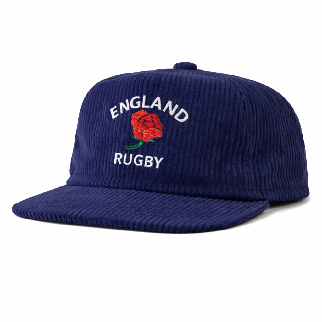 The EMB Weld Nations of Rugby England Corduroy Field Trip Cap is a navy corduroy hat with a curved brim, featuring "ENGLAND RUGBY" and a red rose embroidered on the front—a stylish tribute to rugby heritage.