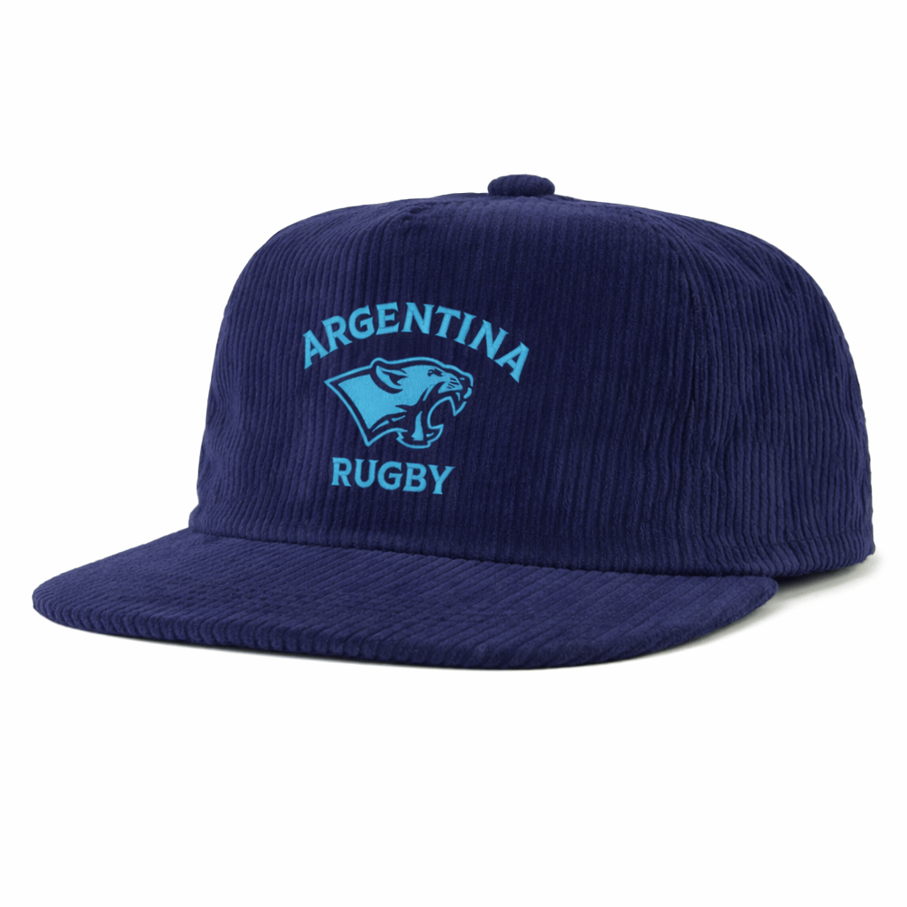 The EMB Weld Nations of Rugby Argentina Corduroy Field Trip Cap is a navy blue corduroy hat featuring "Argentina Rugby" and a light blue puma logo embroidered on the front.