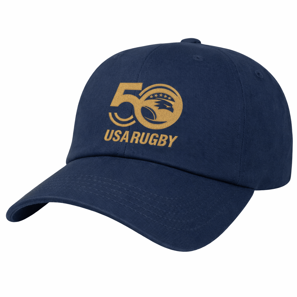 The EMB S&S Activewear USA Rugby 50th Anniversary Cotton Twill Dad Cap features a navy blue design with a gold "50 USA Rugby" logo and eagle emblem on the front, celebrating 50 years of USA Rugby.