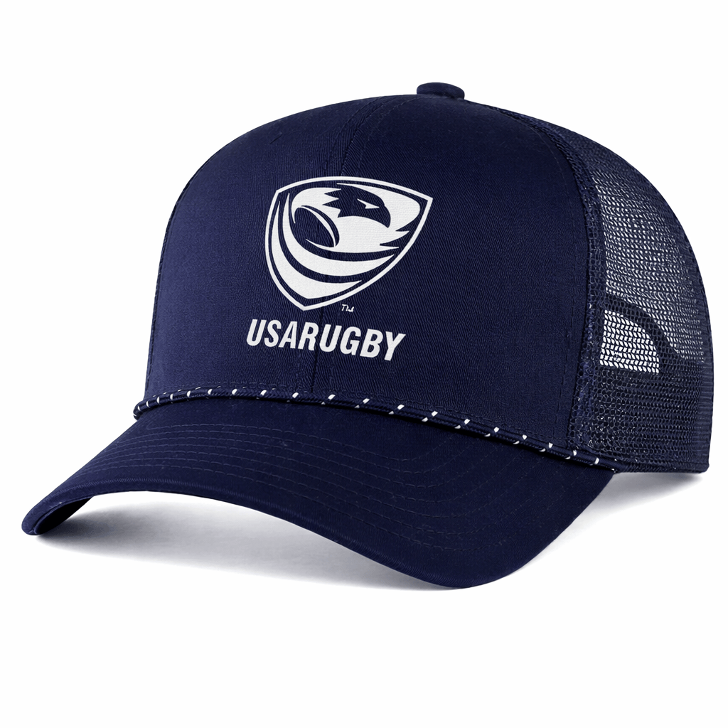 The EMB Augusta USA Rugby Navy/White Crest Braid Cap is a mesh trucker snapback featuring the USA Rugby logo and text on the front, with white stitching along the brim—a timeless cap for any fan.