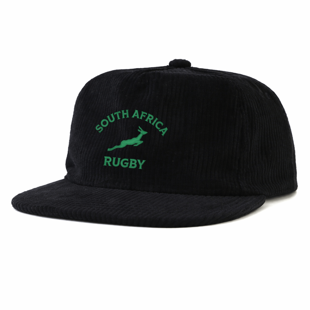 The EMB Weld Nations of Rugby South Africa Corduroy Field Trip Cap features black corduroy, embroidered green “South Africa Rugby” text, and a springbok logo—the perfect collectible cap for any rugby fan.