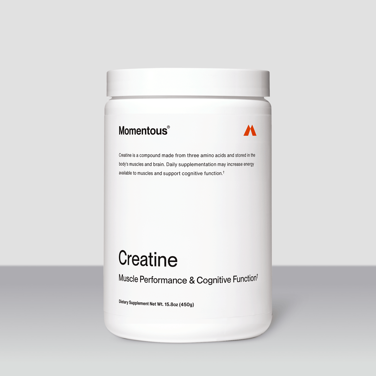 A white container labeled "Momentous Creatine" by Momentous, known for supporting muscle growth and cognitive function, sits on a neutral background.