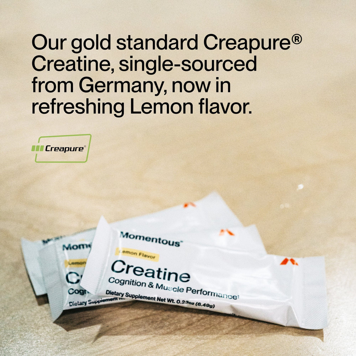 Two Momentous Creatine 15-Travel Packs sit on a light wooden surface, with text above highlighting its premium ingredients, muscle recovery support, and convenient travel-friendly packs.
