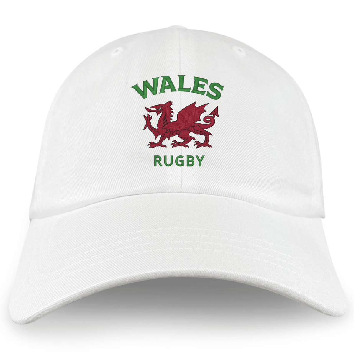 The Nations of Rugby Wales Dad Cap by EMB S&S Activewear is a white cotton hat embroidered with "WALES RUGBY" in green and a bold red Welsh dragon—perfect for fans.