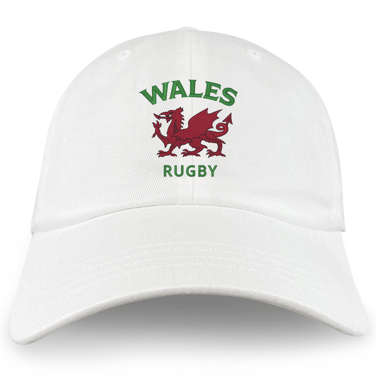 The Nations of Rugby Wales Dad Cap by EMB S&S Activewear is a white cotton hat embroidered with "WALES RUGBY" in green and a bold red Welsh dragon—perfect for fans.