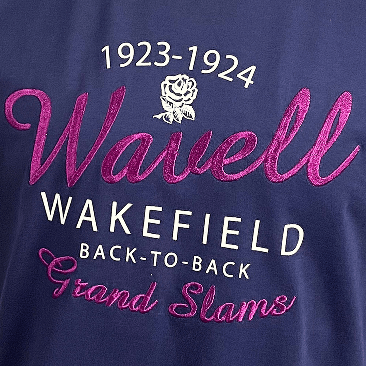 Navy blue Ellis Rugby England Rugby 1924 Grand Slam Shirt featuring the embroidered text "1923-1924 Wavell Wakefield Back-to-Back Grand Slams" and a rose emblem, inspired by the Ellis Rugby collection.