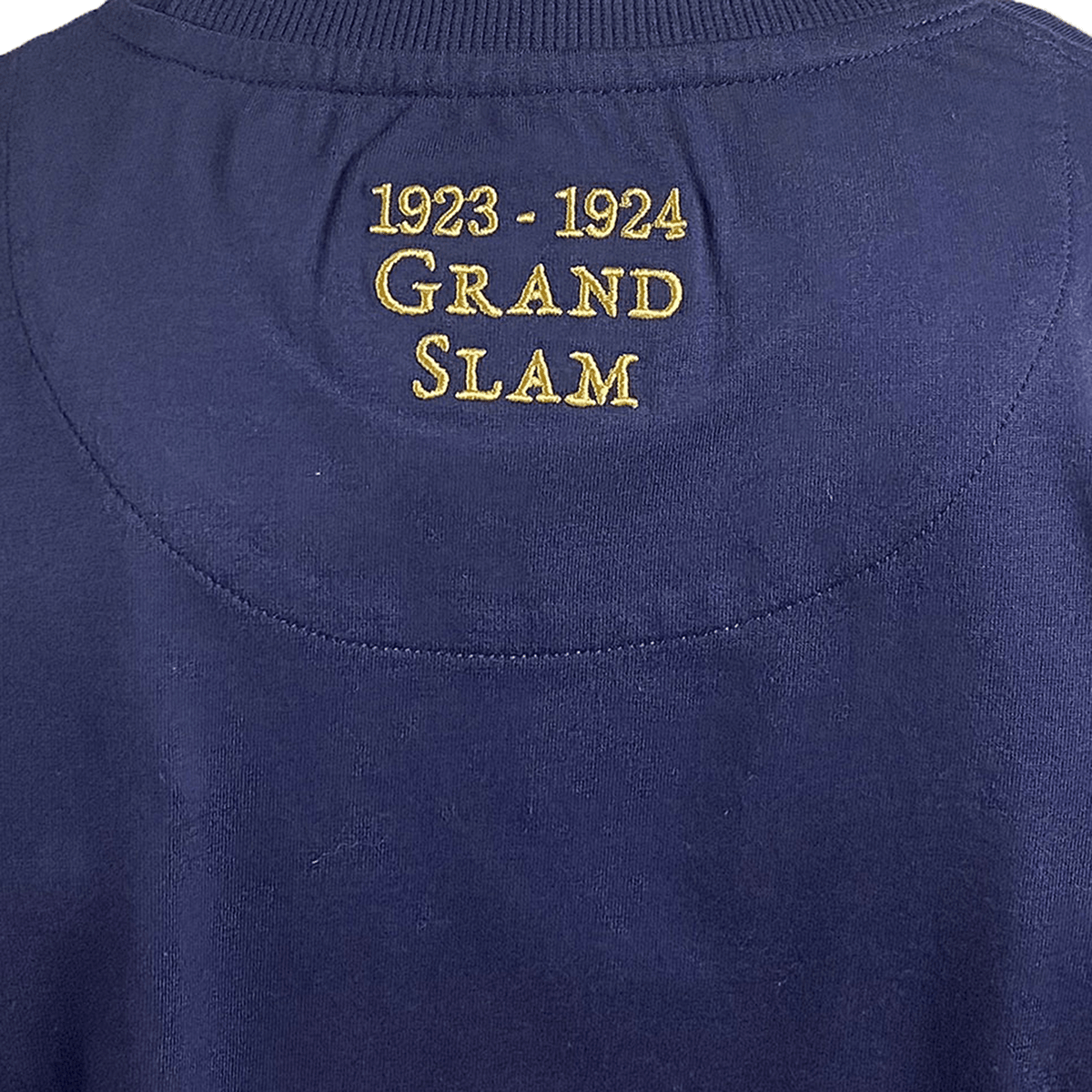 The Ellis Rugby England Rugby 1924 Grand Slam Shirt is a navy blue Ellis Rugby garment with gold embroidery, featuring "1923-1924 Grand Slam" on the back.