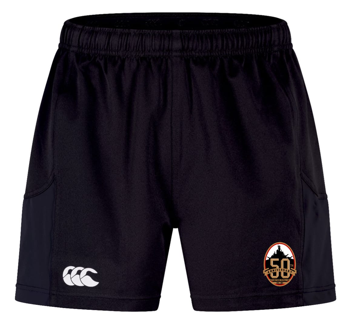The EMB Canterbury Battleship Rugby Club 50th Anniversary Advantage Short 2.0 has an elastic waistband, a white Canterbury logo on the left leg, and an orange and black team logo on the right—comfortable, sustainable sportswear.