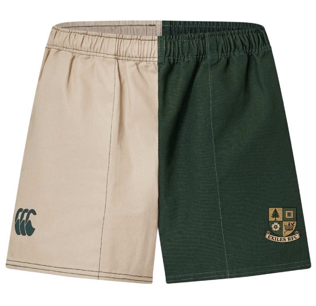 The Exiles Rugby Fundamental Harlequin Drill Short by EMB Canterbury features beige and dark green vertical panels, "CCC" and crest with "EXILES RFC" logos—ideal for rugby training or everyday comfort.