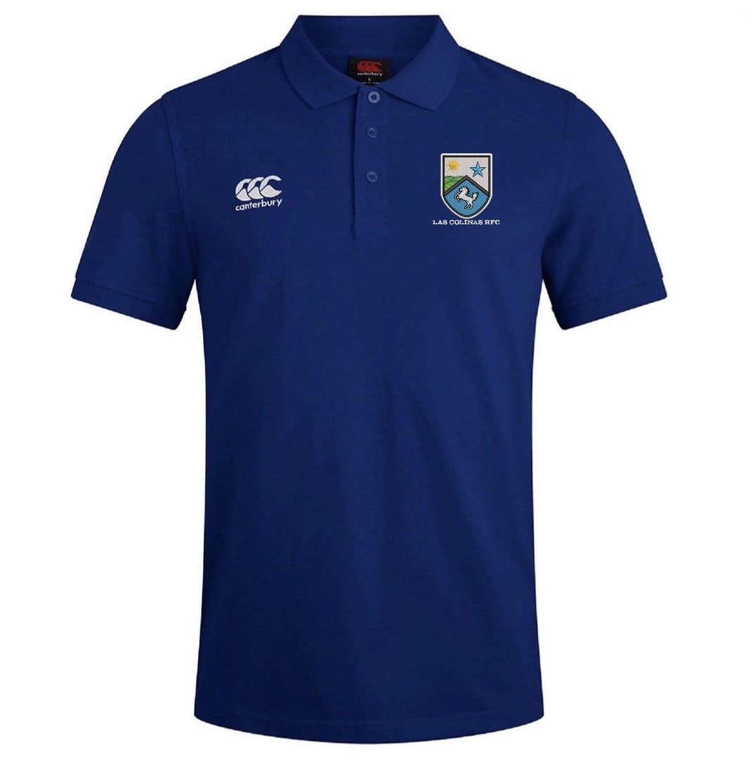 The Las Colinas Rugby Royal Waimak Polo by EMB Canterbury is a blue short-sleeved men's polo with a collar, featuring the Canterbury logo on the right chest and team crest on the left—perfect for rugby fans.