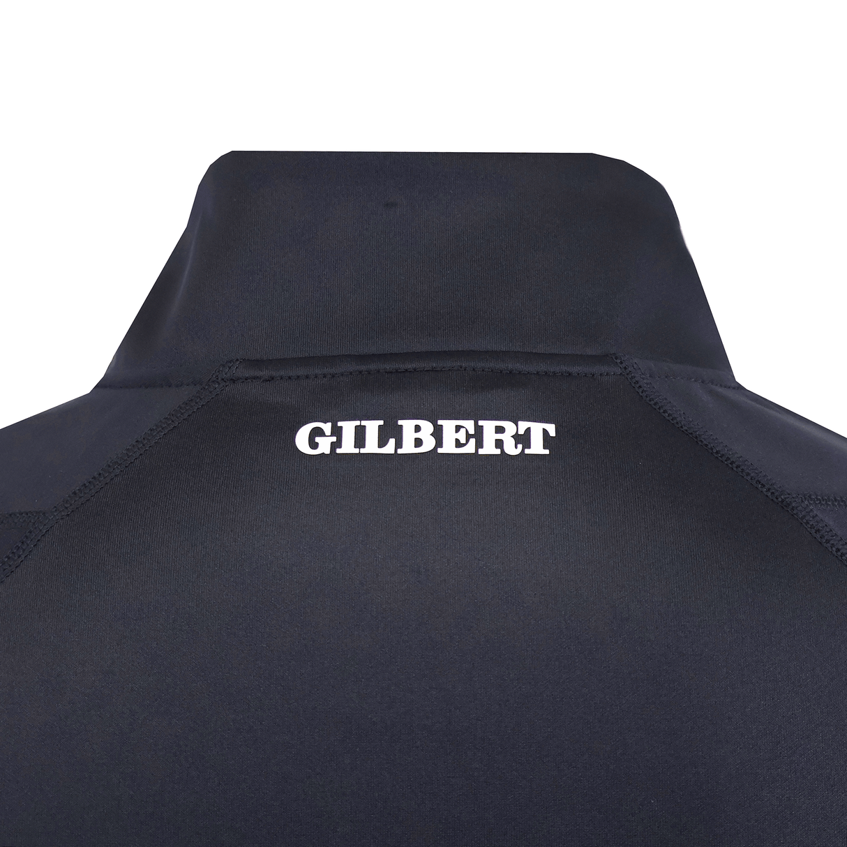 Close-up of the upper back of a dark Gilbert GTS 1/4 Zip Poly Pullover by Gilbert, featuring "GILBERT" printed in bold white letters.