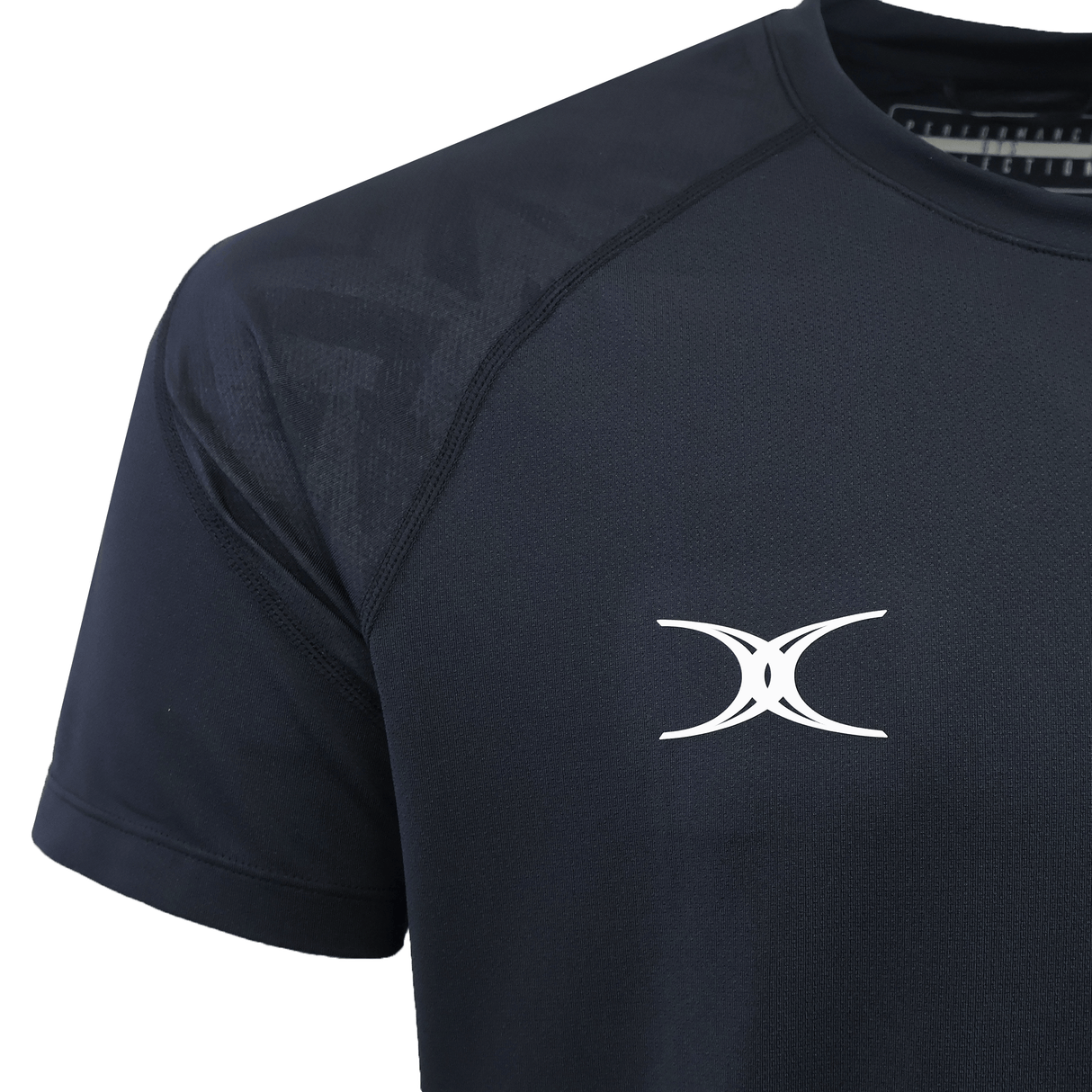 Close-up of the Gilbert GTS Training Tee by Gilbert in dark navy, featuring a white abstract logo on the chest. Designed for peak performance and moisture wicking, showing upper torso and partial sleeve.