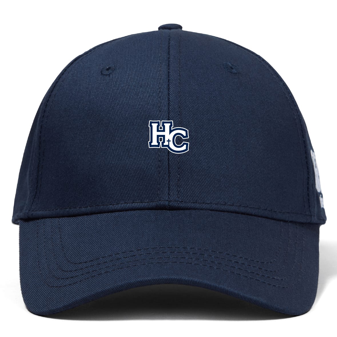 The Holy Cross Flexfit Drill Cap by EMB Canterbury is a navy blue cap with a white and blue "HC" embroidered logo on the front.