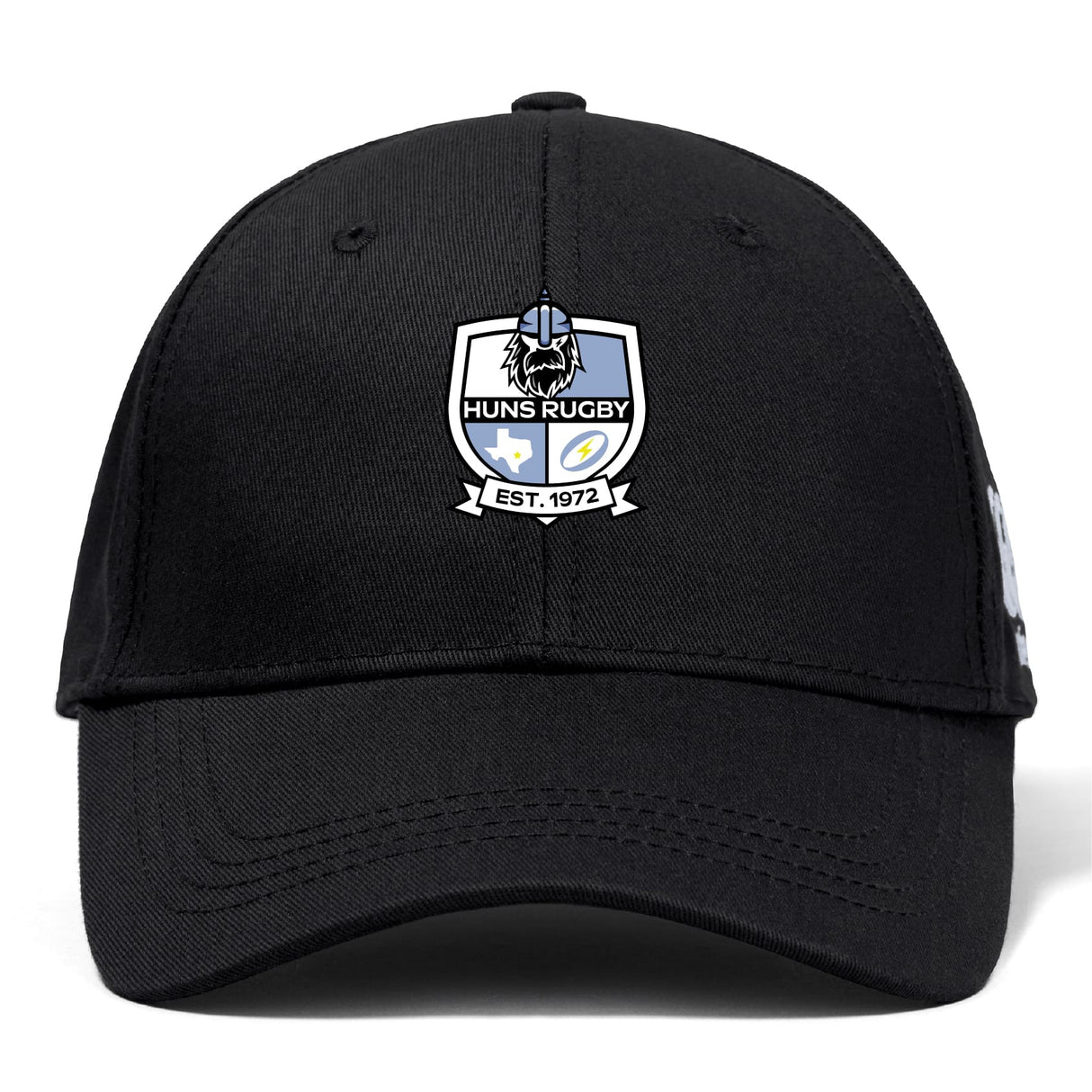 The Austin Huns Rugby Flexfit Drill Cap by EMB Canterbury is a black curved brim cap featuring the Huns Rugby embroidered logo patch and "EST. 1972" on the front.