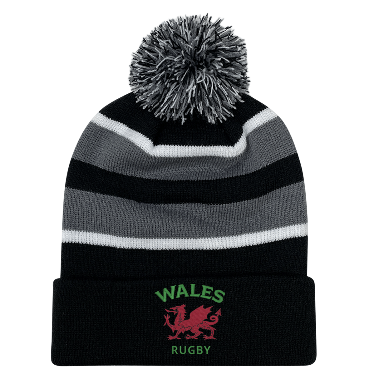 The EMB Augusta Nations of Rugby Wales Hooped Knit Fold Over Pom-Pom Beanie features black, grey, and white stripes, "WALES RUGBY" text, a pom-pom top, and an embroidered red dragon logo on the front.