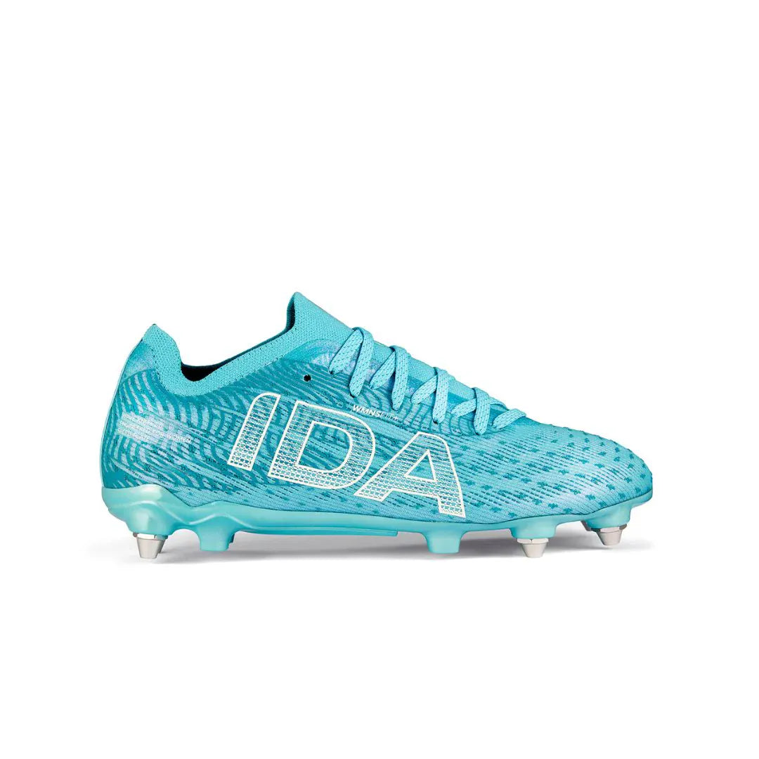 The Ida Women's Helia Pro SG – Blue by IDA Sports is a turquoise soccer cleat with white brand logo, patterned texture, blue laces, and metal studs for pro performance—ideal for wet and muddy fields—shown on a white background.