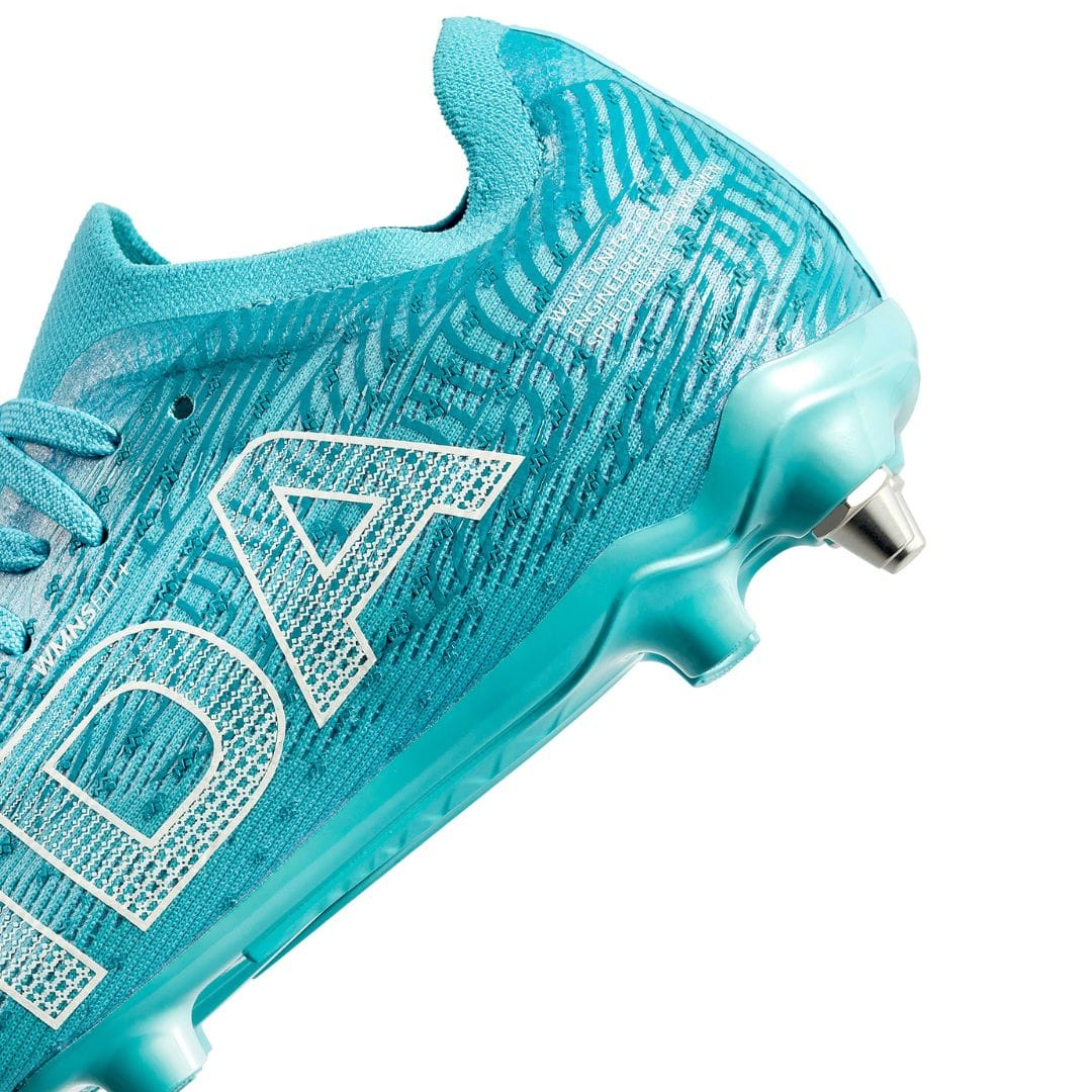 Close-up of the IDA Sports Ida Women's Helia Pro SG - Blue cleat with white textured patterns, featuring side branding and metal-tipped studs—ideal for excelling on wet and muddy soccer fields.
