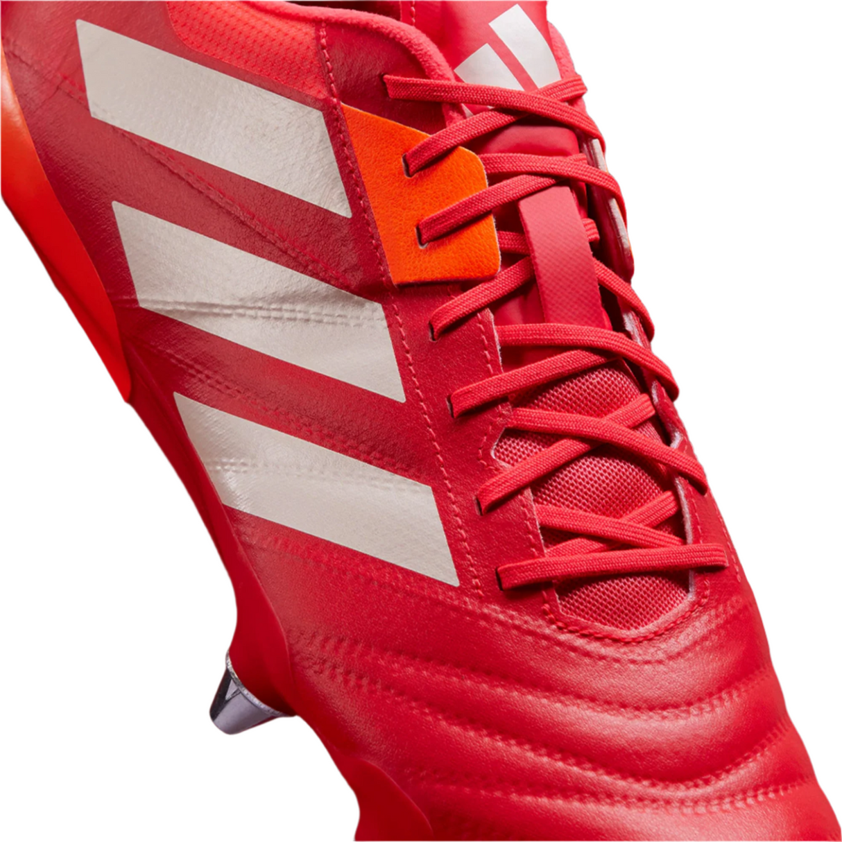 Close-up of the adidas Kakari RS SG rugby boot in Lucid Red/White/Team Solar Orange, featuring white stripes, red laces, metal stud, and a lightweight build.