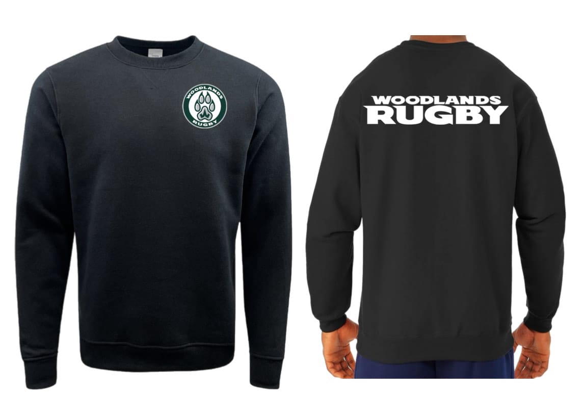 The WRS Augusta Woodlands Youth Paw Print Pocket Logo Crewneck is a black fleece sweatshirt with a circular paw print logo on the front left chest and “WOODLANDS RUGBY” printed in white across the back.