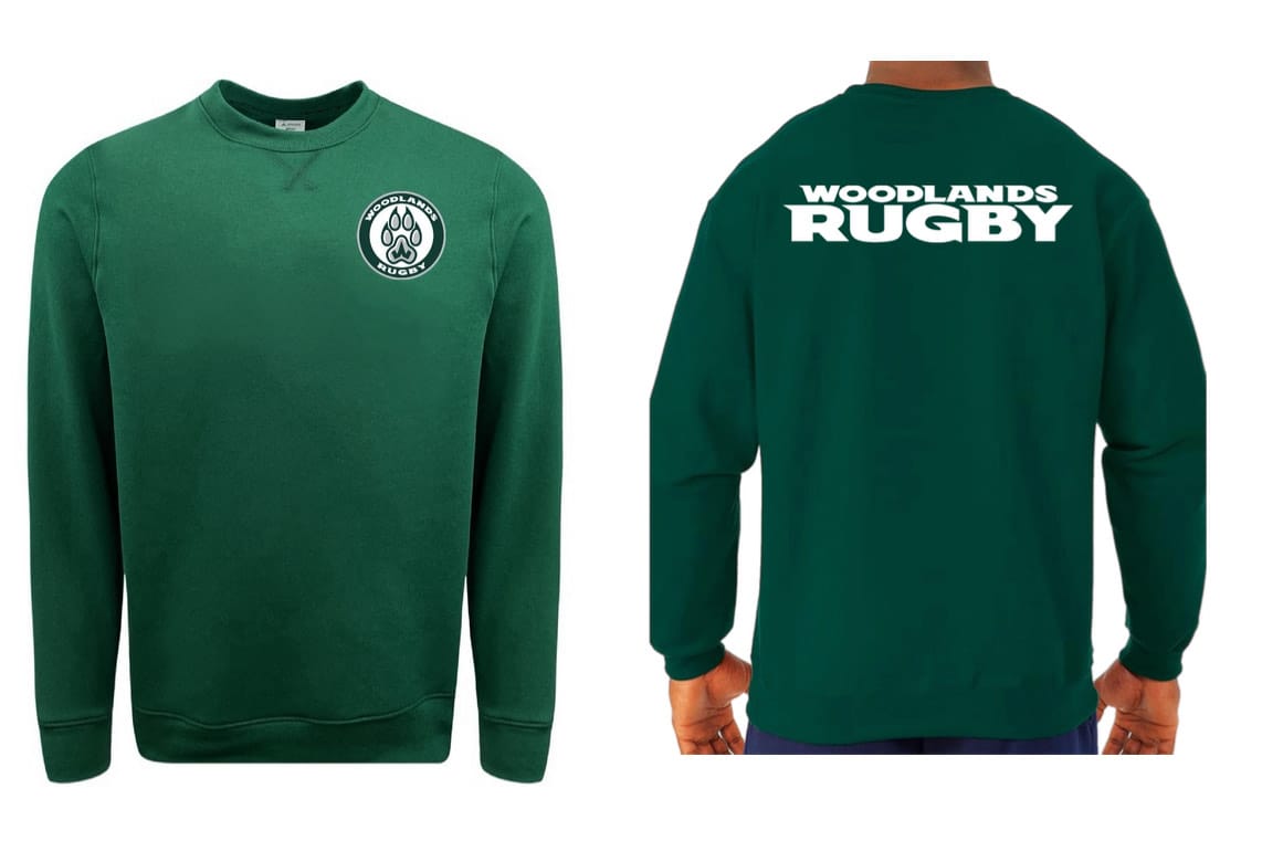The WRS Augusta Woodlands Youth Paw Print Pocket Logo Crewneck is a green fleece sweatshirt with a small paw print pocket logo on the front left chest and large “WOODLANDS RUGBY” text on the back.