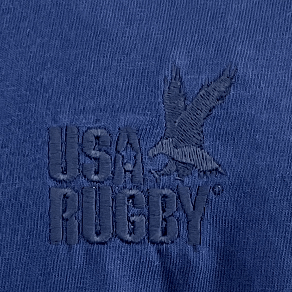 Close-up of the EMB S&S Activewear USA Rugby Elevated Throwback Tonal Comfort Tee - Navy, made from ring-spun USA cotton and featuring an embroidered USA Rugby logo with an eagle in flight above the text.