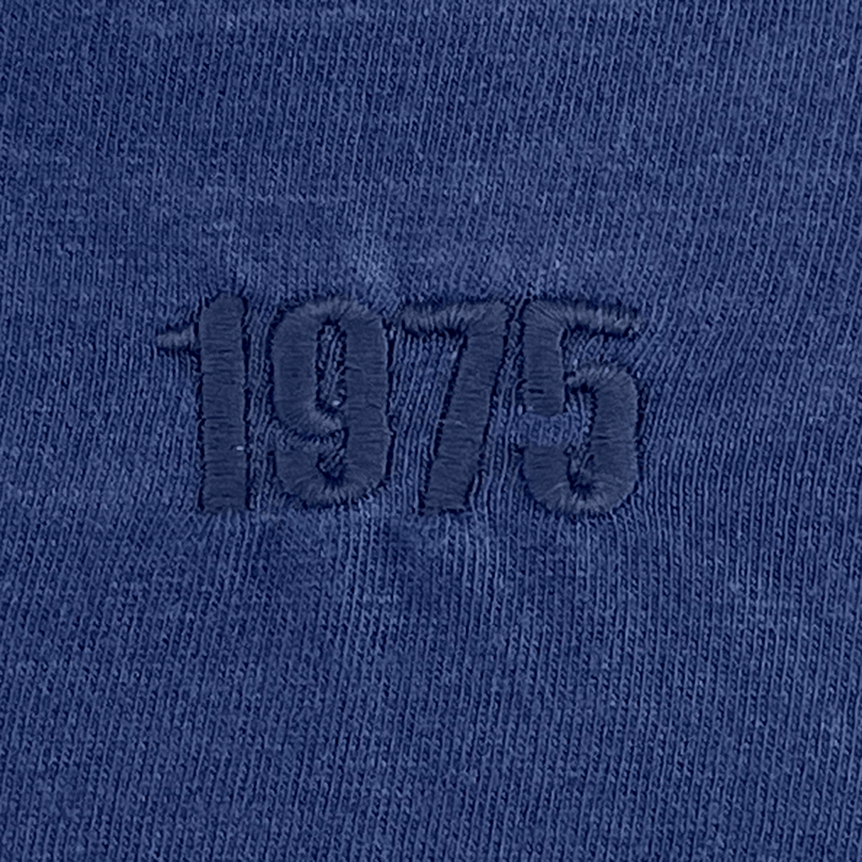 Close-up of the EMB S&S Activewear USA Rugby Elevated Throwback Tonal Comfort Tee in Navy, crafted from ring-spun USA cotton and featuring "1975" embroidered in tonal thread.
