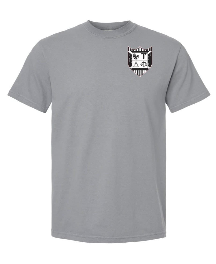 The Troy Rugby Comfort Tee by EMB S&S Activewear is a gray short-sleeve shirt crafted from ring-spun USA cotton, featuring a black and white shield emblem with letters and symbols on the upper left chest.