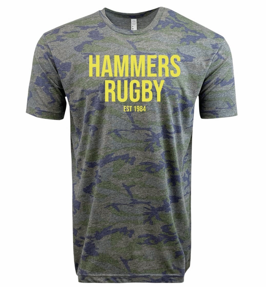 The Montgomery Yellowhammers "Hammers Rugby" Supersoft Tee by WRS LAT features a gray and blue camo design with "HAMMERS RUGBY EST 1984" in yellow. This unisex tee is made from supersoft cotton for all-day comfort.