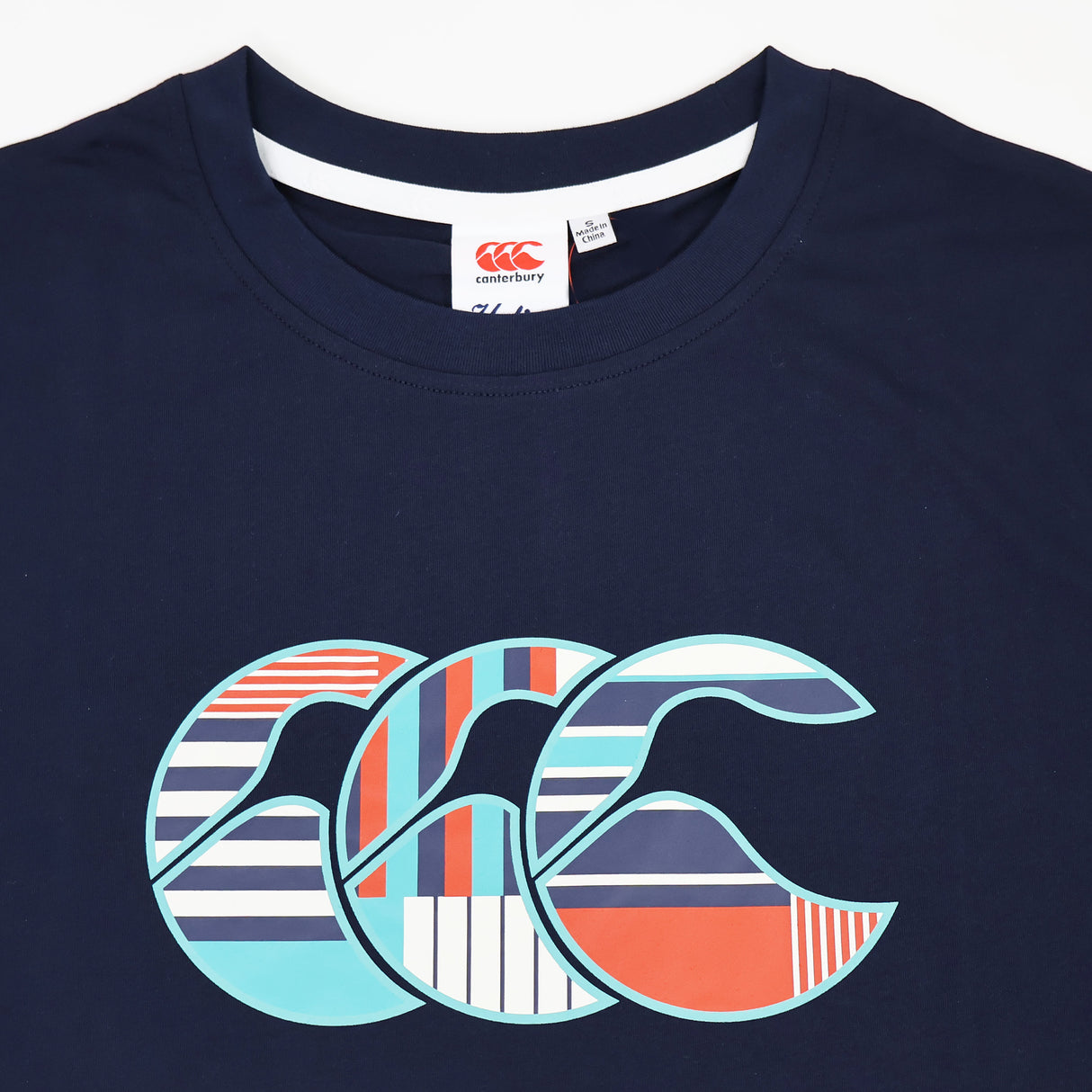 The Canterbury Uglies Logo T-Shirt by Canterbury is a navy blue women’s rugby tee showcasing a large, stylized “CCC” logo with multicolored stripes and geometric patterns across the chest—a bold choice for making a statement on or off the field.