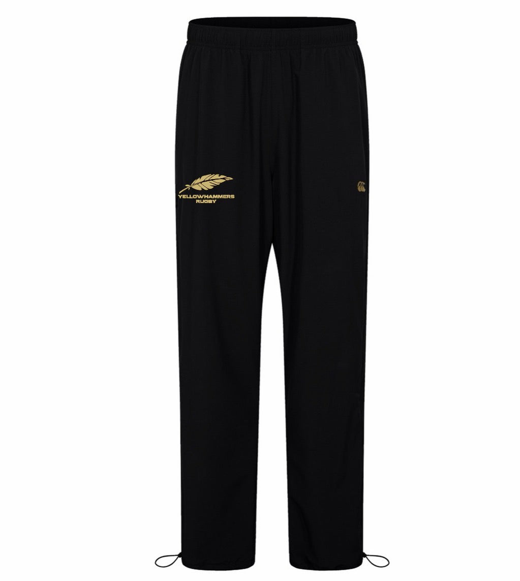 The Montgomery Yellowhammers Tempo+ 32″ Trackpant by EMB Canterbury features black athletic poly fabric, an elastic waistband, a gold feather and “Yellowhammer Rugby” logo on the left thigh, and adjustable cords at the ankles—making it the perfect choice for official Montgomery Yellowhammers track pant gear.