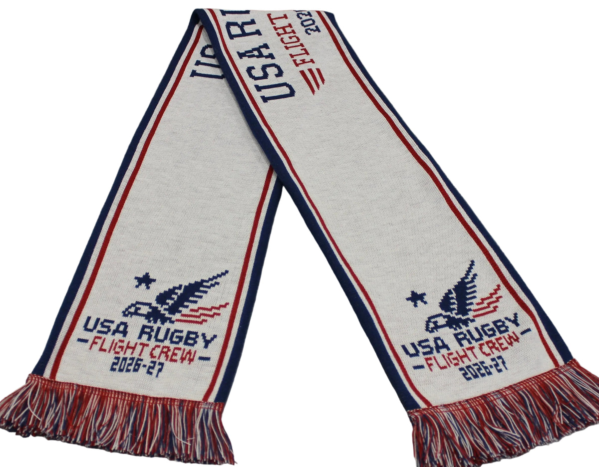 White knit USA Rugby Flight Crew 2026-27 Supporter’s Kit scarf with red and blue stripes, an eagle emblem, “2026-27” text, and fringed ends in red, white, and blue.