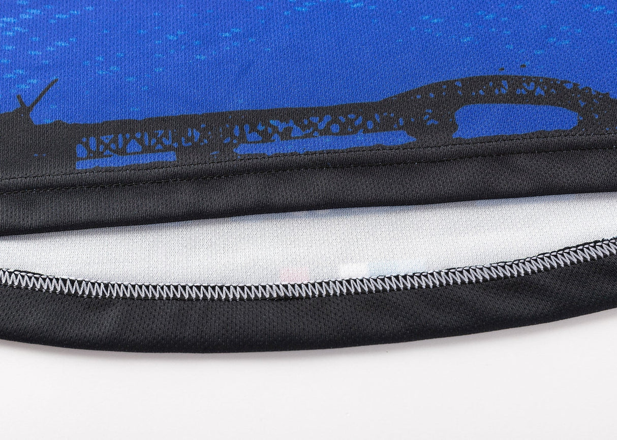 Close-up of blue fabric with black stitching from the Blues Super Rugby 25/26 Replica Home Jersey by Classic Sportswear, featuring a bridge silhouette.