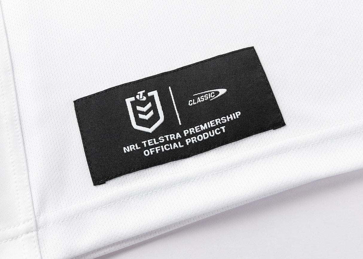 A white fabric label with a black patch and white text reads "NRL Telstra Premiership Official Product" beside the Classic logo, identifying the Dragons NRL 25/26 Replica Home Jersey by Classic Sportswear.